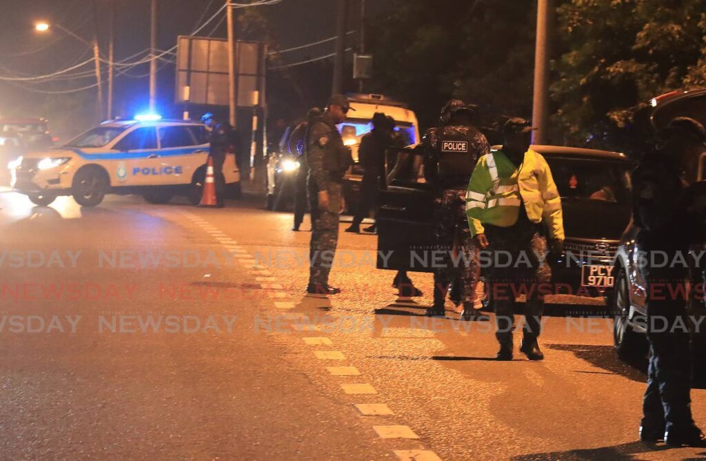 The national security officers conduct road safety check and screening of persons and vehicles entering the captial city of Port of Spain from as early as 3am on Carnival Monday ahead of Jouvert activities. - Photo by Roger Jacob