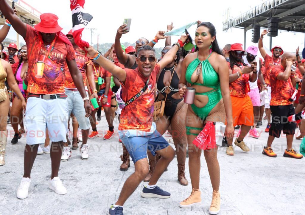 Masqueraders from Ronnie and Caro’s Bushfire enjoy themselves during the Parade of the bands at the Queen’s Park Savannah, Port of Spain. - Photo by Ayanna Kinsale