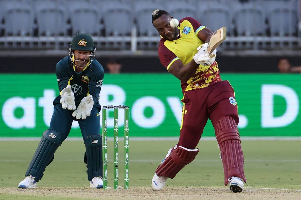 West Indies' Andre Russell plays a shot in front of Australia's wicket-keeper Matthew Wade during the third Twenty20 international at Perth Stadium on February 13. - AP PHOTO