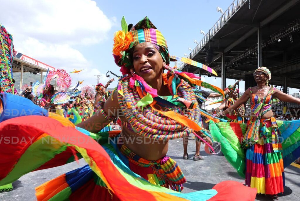 CARNIVAL COLOURS: This masquerader from The Lost Tribe's Fly enjoys herself during the Parade of the bands at the Queen's Park Savannah, Port of Spain on February 13.  - Photo by Ayanna Kinsale