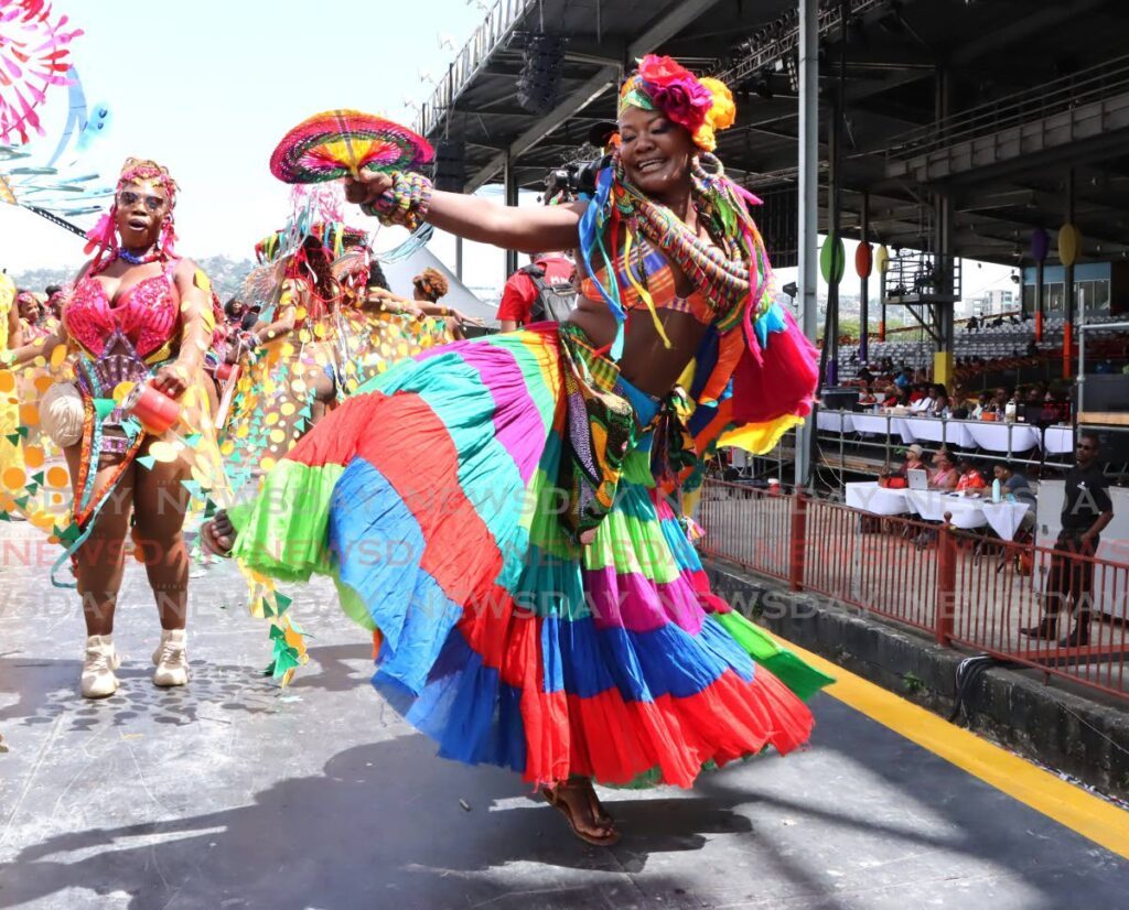 A masquerader from The Lost Tribe's Fly dances on the Queen's Park Savannah stage during the parade of the bands on Carnival Tuesday. The Lost Tribe won the Band of the Year title for its presentation.  - AYANNA KINSALE