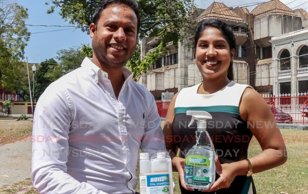 Siblings Yasser Baksh, left, and Mishaal Baksh pose with some of their BIOTECplus products. - Photo by Ayanna Kinsale
