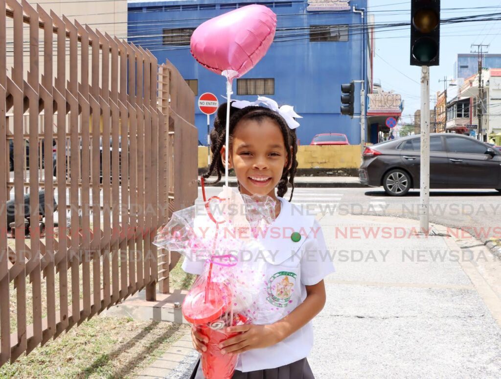Kaylani Seabrun of Trinity Junior Anglican School was all smiles with her Valentine’s Day present on Duke Street, Port of Spain yesterday.  - Photo by Ayanna Kinsale