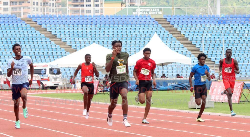 Kadeem Chinapoo (C) of St Benedict’s College easily wins the Boys’ U17 200m during the Secondary Schools Track and Field National Championships, at the Hasley Crawford Stadium, on Wednesday. - Angelo Marcelle