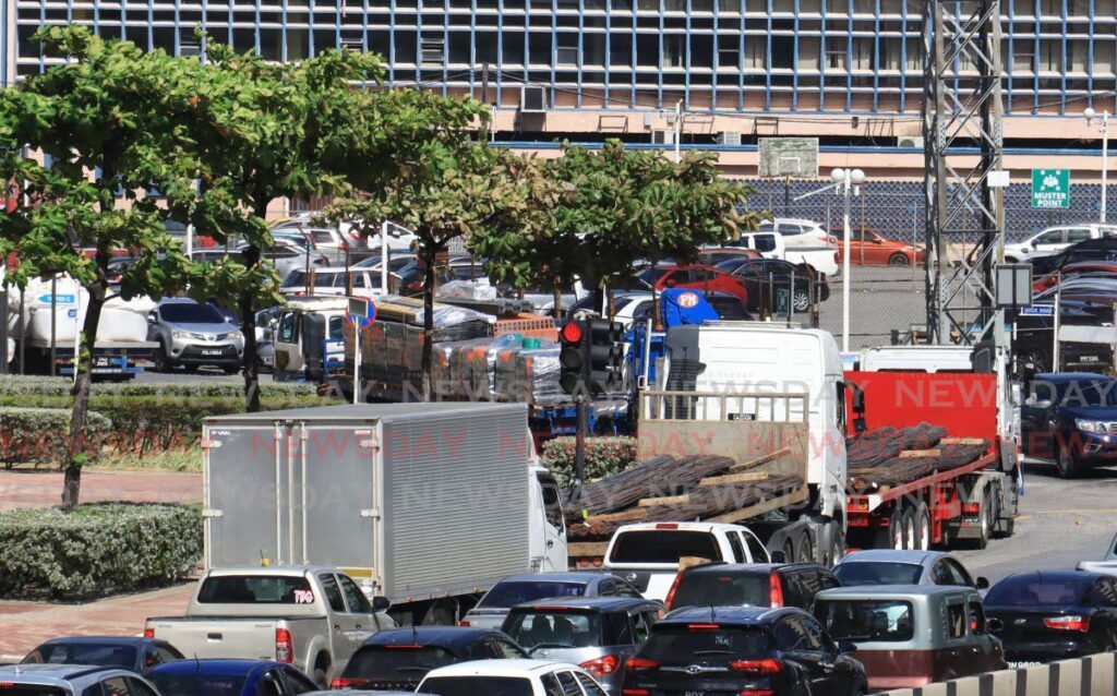 Trucks loaded with cargo park along Wrightson Road and Dock Road in Port of Spain, as they await embark instructions to travel across the sea-bridge on Thursday. - ROGER JACOB