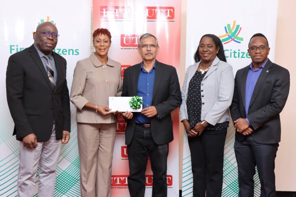 Nadine Harding-Mohan, cluster manager, South, First Citizens, second from left, presents a cheque to UTT president Prof Prakash Persad, alongside university officials at the Point Lisas campus. - Photo courtesy First Citizens Bank