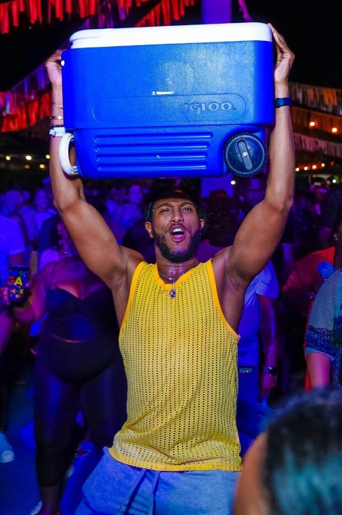 This fete-goer poses for a photo with his cooler in tow at the Blue Range Cooler fete. - Photo courtesy Tribe