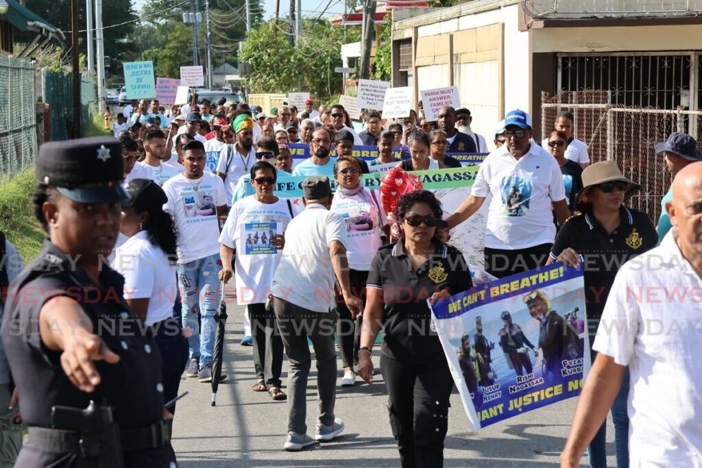 Family and friends of the four divers who died in the Paria tragedy during a walk in Couva to mark the second anniversary of their deaths on February 24.  - Photo by Lincoln Holder 