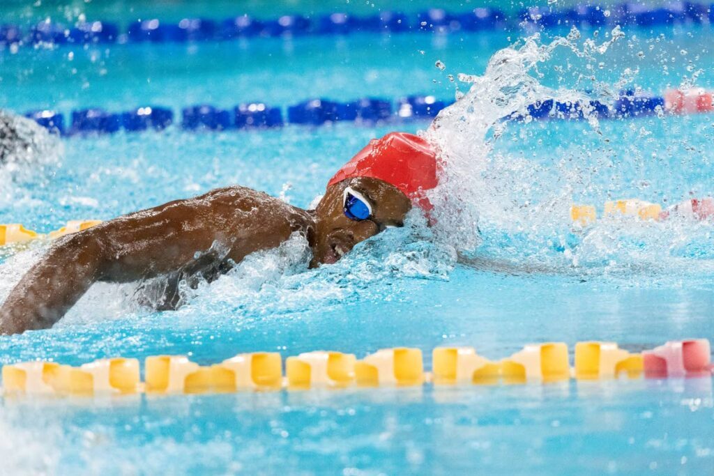 Flying Fish Swimming Club's Jonathan Sambrano splashes to a lead time of 57.22 in Heat 4 of the Boys' 13-14 100m freestyle prelims at the National Long Course Age Group Championships on Thursday night at the National Aquatics Centre, Couva.  -  Dennis Allen for @TTGameplan