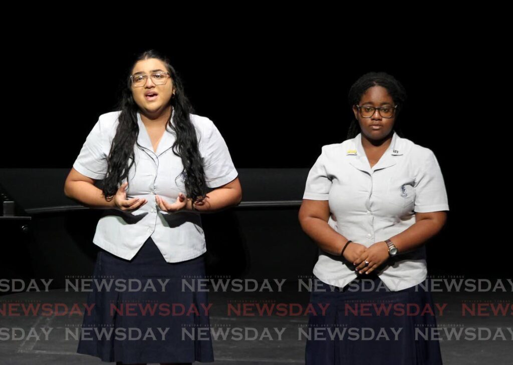 Sierra Smith and Anya-Lee Bidaisee of St Joseph's Convent Port of Spain, perform their test piece, Pie Jesu by Andrew Lloyd Webber, in the category, Girls’ Vocal Duet 16 to 19 Years, putting them in first place in their category at the 35th Biennial Music Festival held at Queen’s Hall, St Ann’s on Monday. - Photo by Faith Ayoung