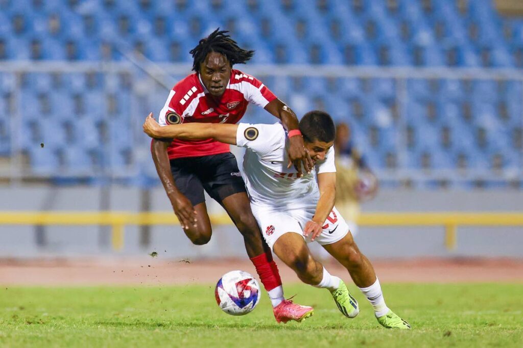 Trinidad and Tobago's Dhurell Young (L) battles for possession of the ball with Canada's Santiago Lopez during the Concacaf Championship Under-20 Group D match, at the Hasely Crawford Stadium, Port of Spain, on February 27. - Photo courtesy TTFA Media
