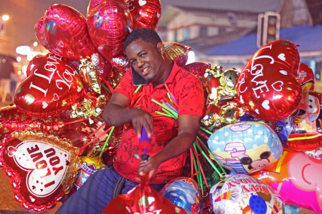 LOVE IS IN THE AIR: Marcus Gibbs Better known as the “The Balloon Guy” waste little time as he airs up love balloons for Valentine's Day. - File photo
