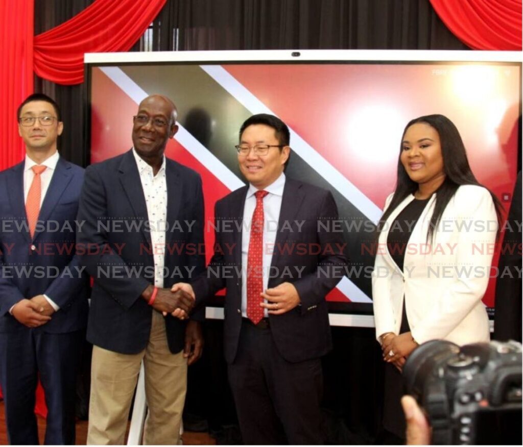 Prime Minister Keith Rowley, second from left, shakes hands with president of Huawei Technologies Daniel Zhou during the Huawei IdeaHub donation ceremony at the Carenage Police Youth Club and Homework Centre, Constabulary Street, Carenage in November 2023. File photo by Ayanna Kinsale