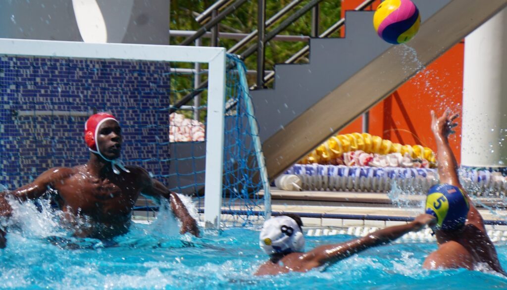 QRC's Kerne Dick (L) guards his goal closely during Republic Bank Secondary Schools' Water Polo League (SSWPL) action against Fatima College at the National Aquatic Centre in Couva on February 24. - Photo courtesy Dawn Hackett