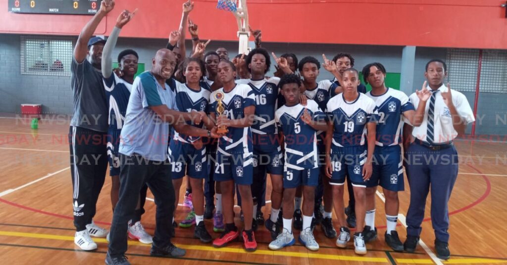 Secondary Schools Basketball East Zone chairman Ishmael St Bryce presents the Under-15 trophy to Trinity College East at the Maloney Indoor Sport Arena on March 15. - Photo by Jelani Beckles