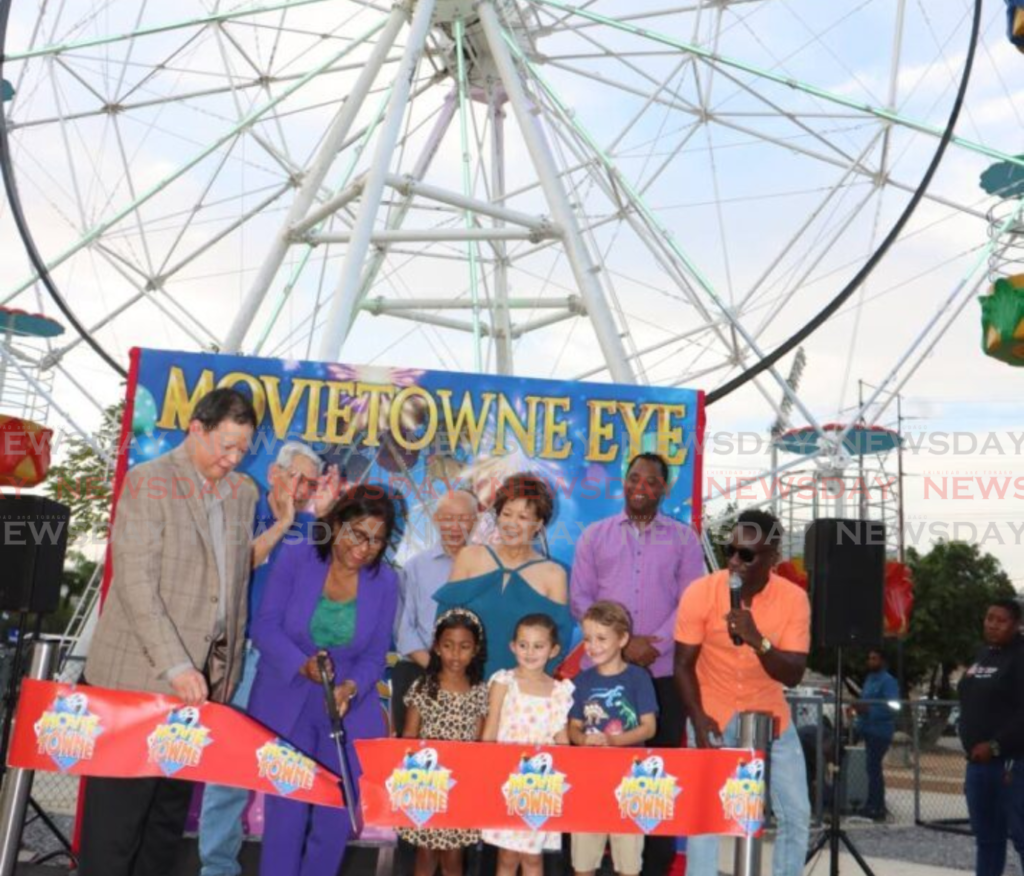 Trade Minister Paula Gopee-Scoon (second from left) cuts the ribbon to officially open the MovieTowne Eye (Ferris wheel) on March 8. - Photo by Angelo Marcelle