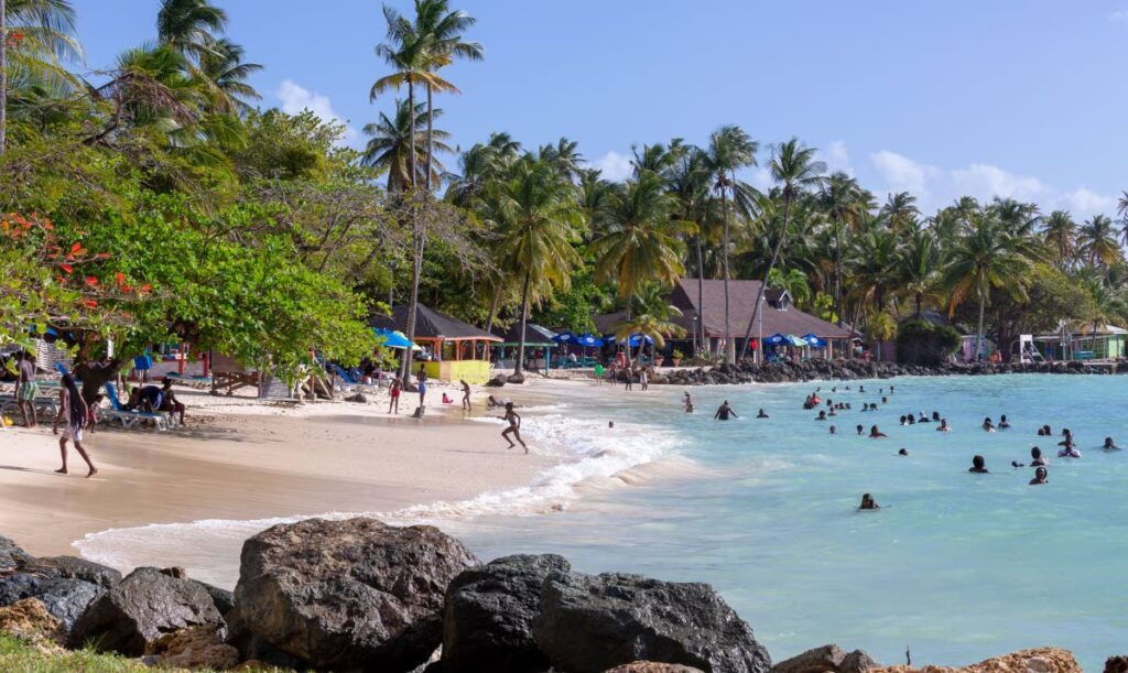 FUN IN THE SUN: People enjoying themselves at Pigeon Point beach, Tobago. - File photo