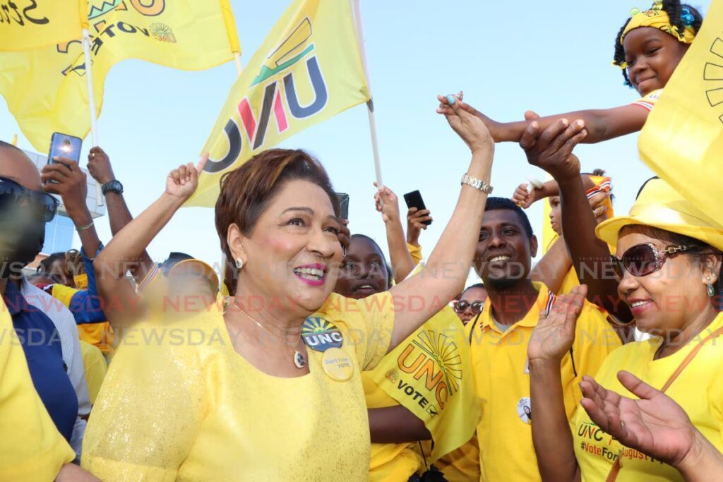 UNC Political Leader Kamla Persad-Bissessar surrounded by supporters at a UNC rally. - File photo