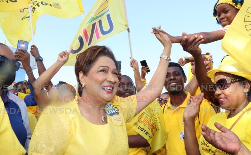 UNC Political Leader Kamla Persad-Bissessar surrounded by supporters at a UNC rally.