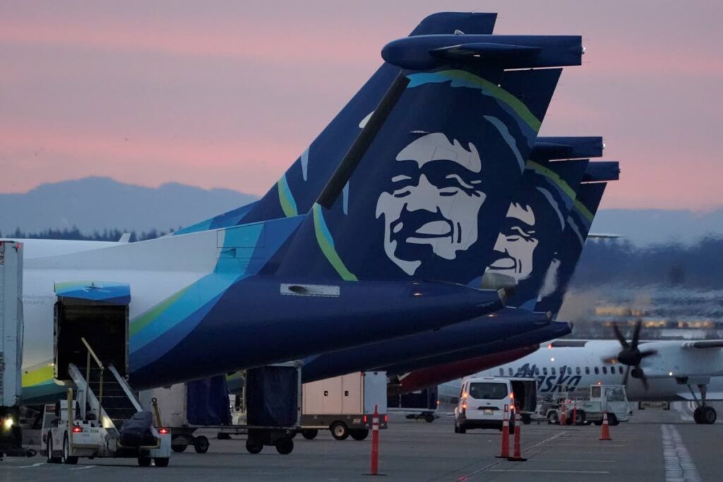  Alaska Airlines planes are shown parked at gates at Seattle-Tacoma International Airport in Seattle. - AP Photo