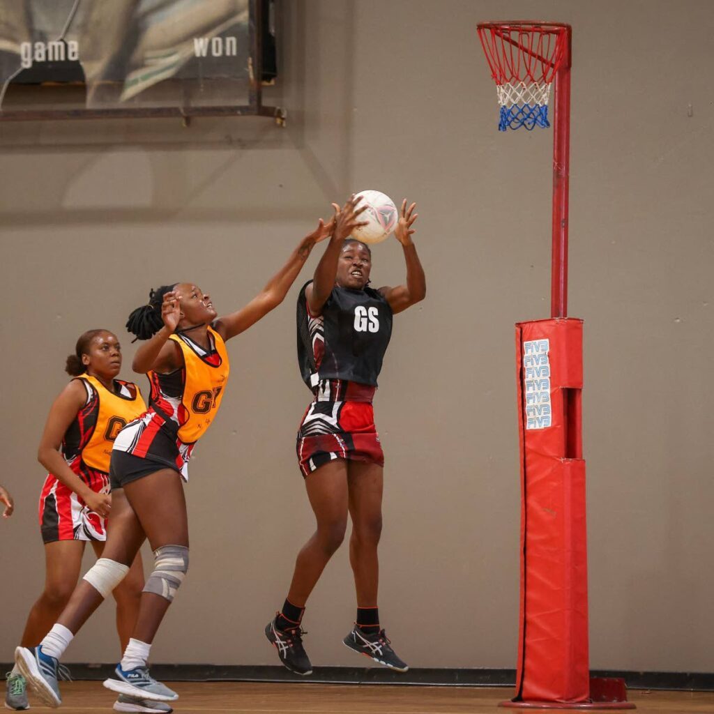 TTPOST Goal Scorer Nekiesha Gomes, right, claims possession of the high pass while under pressure from UTT Patriots Goalkeeper GeorgeAnn Horsford during the All Sectors Netball Tournament Championship division match at the Eastern Regional Sporting Indoor Arena on January 27 in Tacarigua.  - Photo by Daniel Prentice