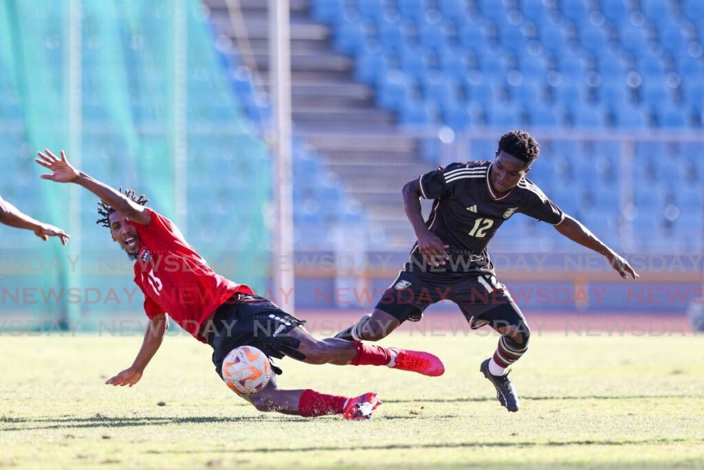 Trinidad and Tobago’s Rhondel Gibson, left, gets fouled by Jamaica’s Devonte Campbell during a friendly match at the Hasely Crawford Stadium, Mucurapo on March 1. - Photo by Daniel Prentice