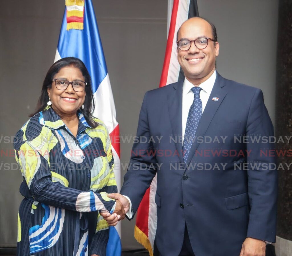 Acting Minister of Foreign and CARICOM Affairs and Minister of Trade and Industry Paula Gopee-Scoon and ambassador Wellington Bencosme shook hands as a sign of the good relations exist between both countries during the reception for the 180th anniversary of the independence of the Dominican Republic on February 27 in Port of Spain. - Photo by Grevic Alvarado