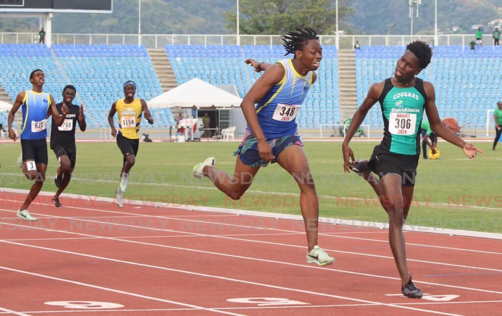 Cougars’ Kyrell Thomas (R) crosses the finish line in first place in the boys’ Under-20 400m dash, during the 2024 NAAATT Carifta Trials, on Saturday, at the Hasely Crawford Stadium, Port of Spain. - Angelo Marcelle