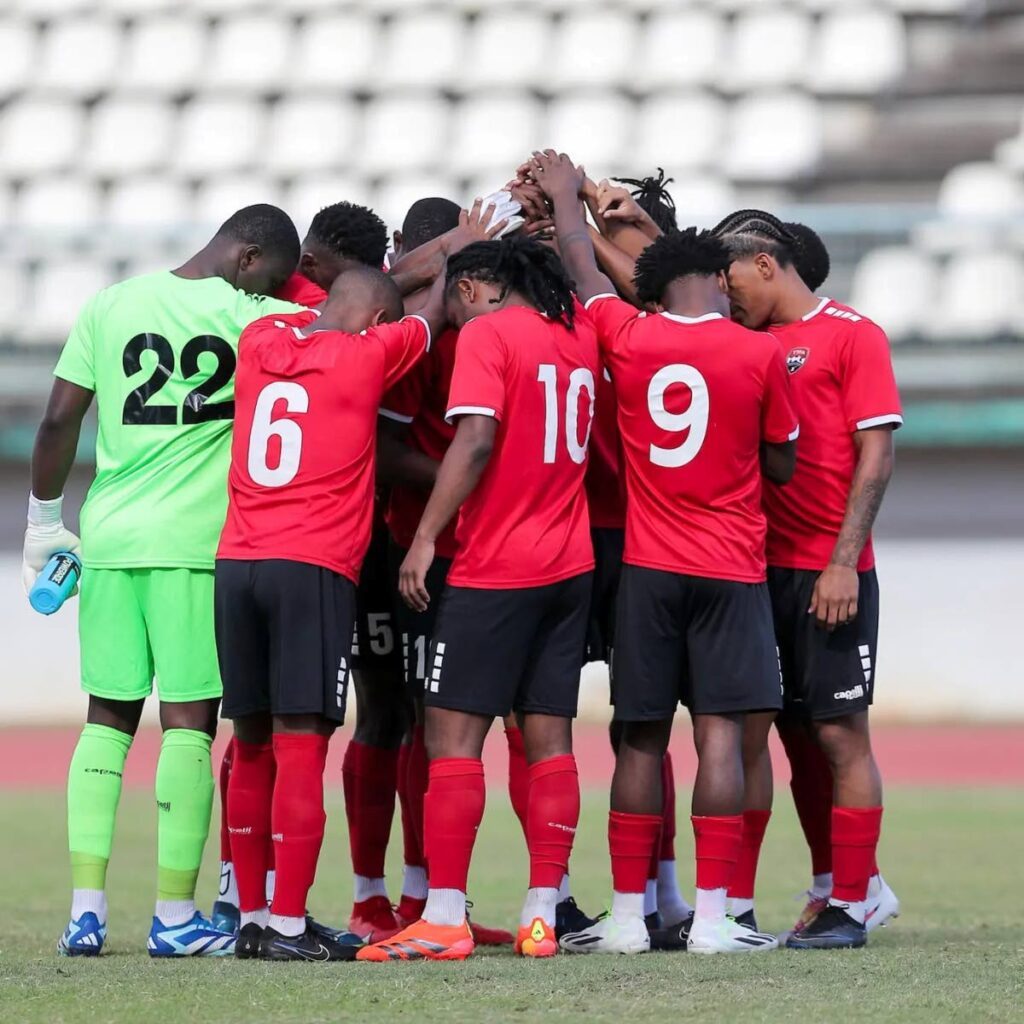 Huddle up: Trinidad and Tobago's men's football team come together before kickoff in their friendly encounter against Jamaica at Larry Gomes Stadium, Malabar on March 3. - Photo courtesy TTFA