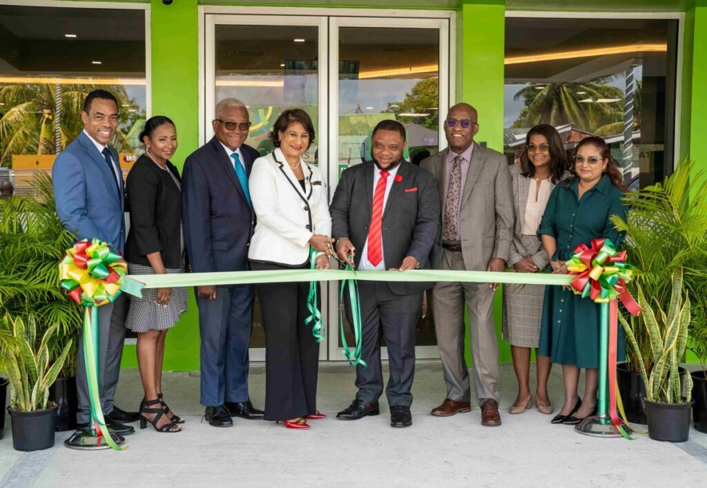 RIBBON CUTTING: Jason Julien, Group deputy CEO, business generation, left; Cheryl-Ann La Roche, head of retail banking; Anthony I Smart, chairman; Karen Darbasie, Group CEO; Roger Monroe, MP for Toco/Sangre Grande; Patrick Solomon, the inspector of financial 
institutions of CBTT; Sana Ragbir, general manager, retail and commercial banking; and Cindy Rackal, manager of Sangre Grande branch.
Photo courtesy FCB - 