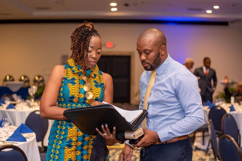 From left, Carolyn Gardner and Alex V Sterling, a member of the Rotary Club of Kingston, discussed the final details for the club's installation ceremony in 2022, where Alex was the event planner. - Photo courtesy Keron Rose