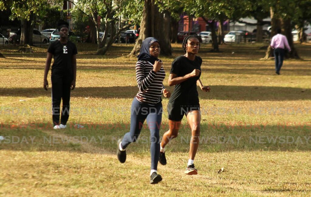 Aleisha St Louis, left, trains two of her athletes, Amelia Pompey and Kaya Subero, both from Bishop's Centenary College. St Louis is the coach for the recently established Port of Spain branch of the D'Abadie Progressive track and field club.  - Photo by Faith Ayoung