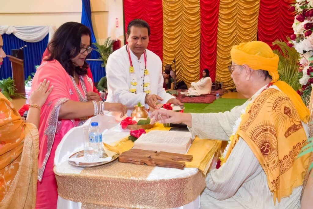 THANKSGIVING: Lakshmi Girls Hindu College Principal, Sonia Mahase-Persad, participates in a puja at the school to mark its 60th anniversary. The puja was officiated by Dharmacharya, Pundit Dr Rampersad Parasram, right. Also in photo is Pundit Sunesh Tota-Maharaj. Photo courtesy Lakshmi Girls Hindu College 