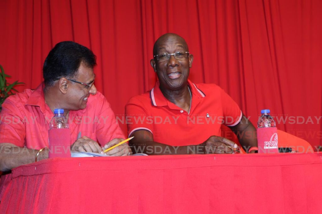 Prime Minister Dr Keith Rowley, right, and Minister of Works and Transport Rohan Sinanan at the PNM's political meeting, in Chaguanas on March 7. - ANGELO MARCELLE