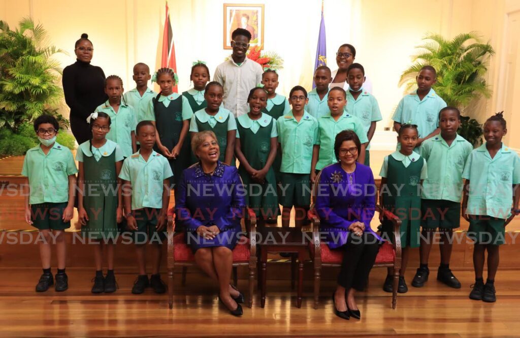 President Christine Kangaloo, right, and Speaker Bridget Annisette-George with students from Patna River Estate Government Primary School at a reading session featuring stories of strong women in commemoration of International Women's Day at President's House on March 8. - Photo by Roger Jacob