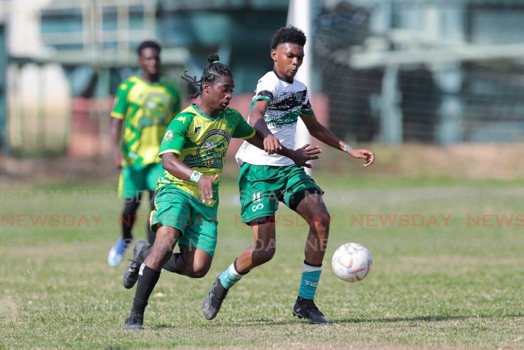 A Signal Hill Secondary player, left, vies for the ball against St Augustine Secondary opponent Giovanni Hospedales in a SSFL Big 5 match recently. - Photo by Daniel Prentice