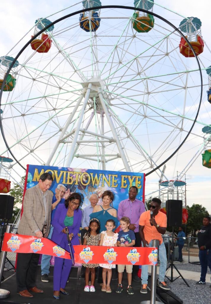 Trade Minister Paula Gopee-Scoon (second from left) cuts the ribbon to officially open the MovieTowne Eye (Ferris wheel) on March 8. - Angelo Marcelle