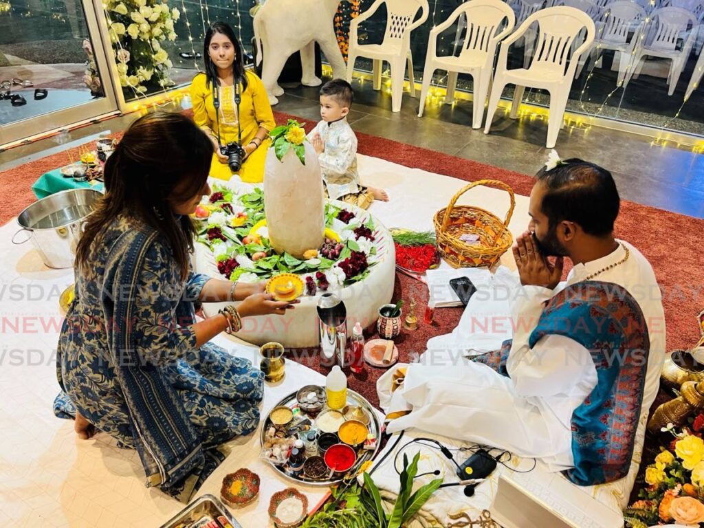 Pundit Veda Persad of the Ramjit and Basso Persad Hindu Temple performs Shivratri puja with devotees on March 8.  - 