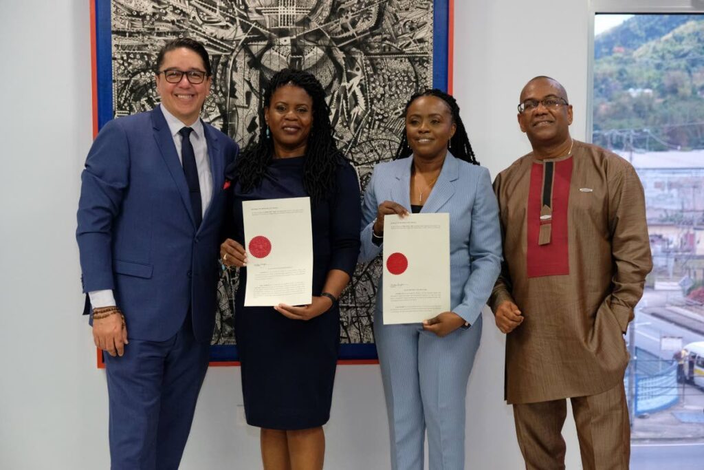 Symon de Nobriga, Minister in the Office of the Prime Minister, left, and at far right, Neil Parsanlal, chairman of the board of Nalis with second from left: Paula Greene and Beverly Williams who were reappointed executive director and deputy executive director of Nalis. - 