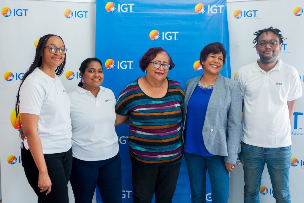 Chelsea Alleyne, IGT administrative assistant, left; Tanya Singh, IGT global people services representative; Ann Marie Rodriguez, Credo Sophia House co-ordinator; Shavindra Tewarie-Singh, IGT People & Transformation regional senior manager-Caribbean; and Darron Marcelle, IGT Courier, join forces to celebrate IWD at Credo Sophia House on March 2. 
Photo courtesy IGT - 