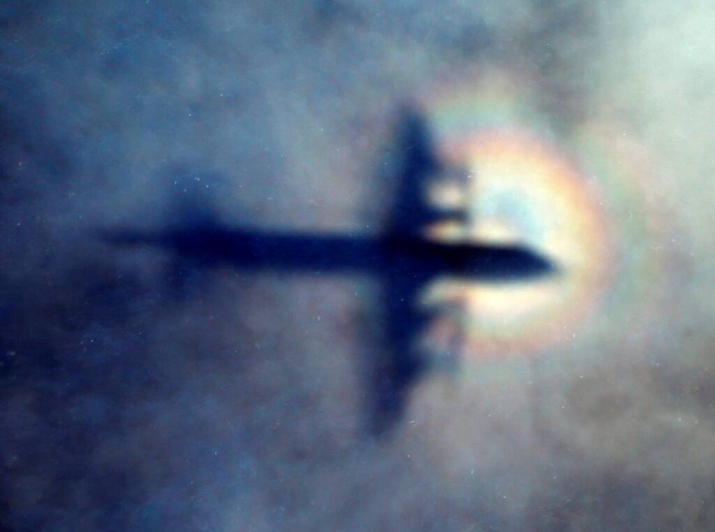 The shadow of a Royal New Zealand Air Force P3 Orion is seen on low level cloud while the aircraft searches for missing Malaysia Airlines Flight MH370 in the southern Indian Ocean, near the coast of Western Australia, on March 31, 2014. AP PHOTO - 