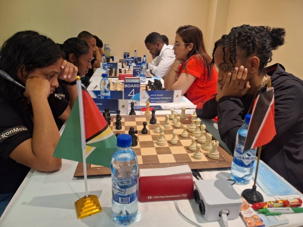 TT's chess team engage in competitive action against Guyana at the inaugural Caricom Classic in Guyana. WCM Zara La Fleur (right foreground) plots her next move. Photo courtesy TT Chess Association.  - 
