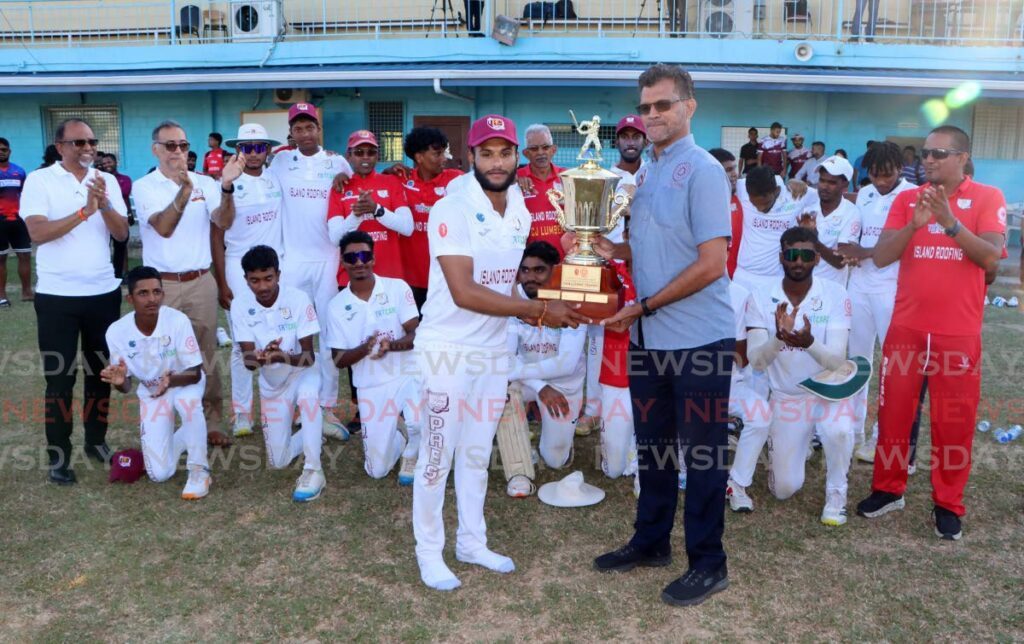 SSCL president Nigel Maraj (R) presents Presentation College Chaguanas captain Nigel Maraj with the trophy after beating Presentation College San Fernando in the final round premier division match, at Presentation College Grounds on March 12.  - Photo by Angelo Marcelle
