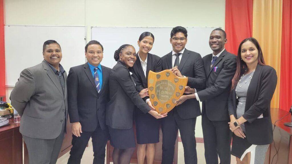The winning members of the Hugh Wooding Law School team which won the regional competition in Jamaica with their coaches.  - 