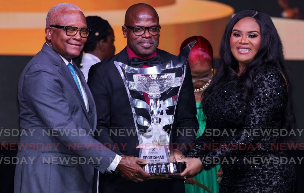 Darren Paul, father of cyclist Nicholas Paul, centre, receives the award for Senior Male Sporstsperson of the Year, on behalf of his son, from Minister of Sports and Community Development Shamfa Cudjoe-Lewis, right, and Anthony Smart, chairman of First Citizens, during the First Citizens Sports Foundation 2023 Sports Awards in Port of Spain on March 16. - Photo by Daniel Prentice