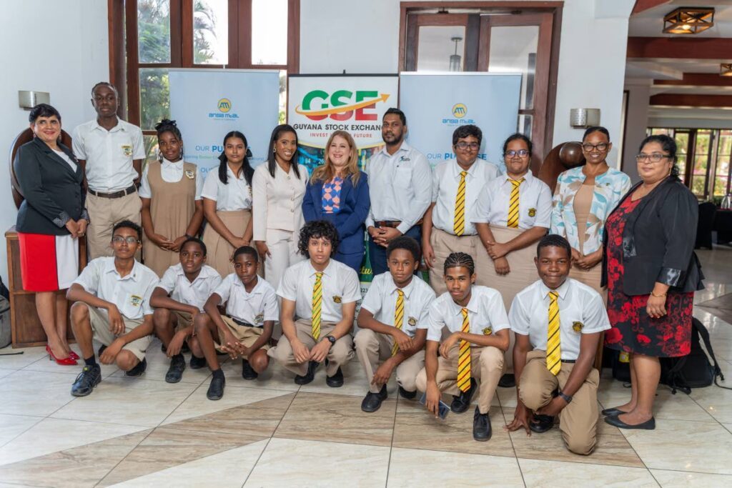Sarah Inglefield, head of culture and communications, Ansa McAl (centre) and Charielle Plowden, country manager, WizdomCRM (centre left), with students of North Ruimveldt Multilateral Secondary School (Guyana) and Queen’s College (Guyana). - Photo courtesy Ansa McAl