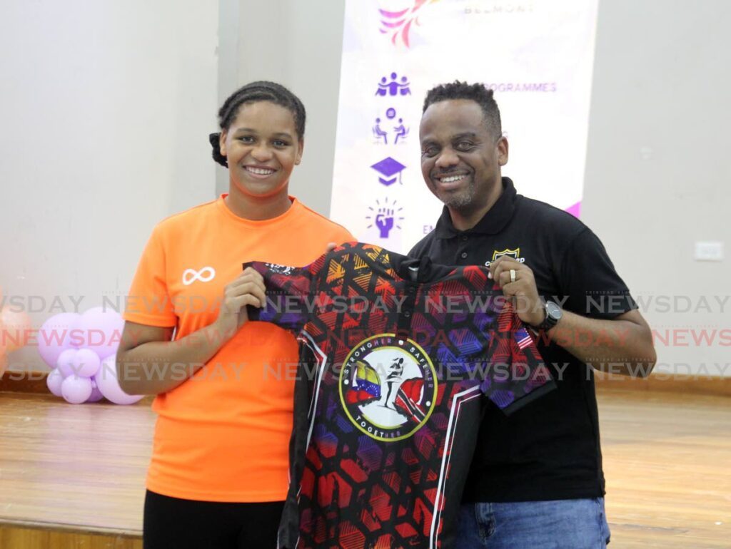 Jaide Gabriel of East Mucurapo Secondary School receives a prize for participation at the Project Phoenix Belmont's Self-Defence Workshop for Teen Girls from at the Belmont Community Centre, Jerningham Avenue, Port of Spain on March 18. - Photo by Faith Ayoung