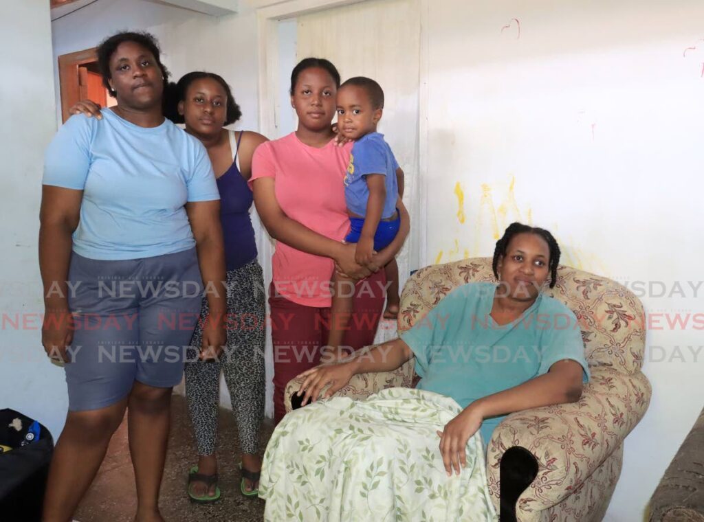 Anita James, right, wife of Harpe Place murder victim Rudolph James, with their children Arita, Abiona, Azia and Adon at the family’s home in Belmont on Monday. - Photo by Roger Jacob