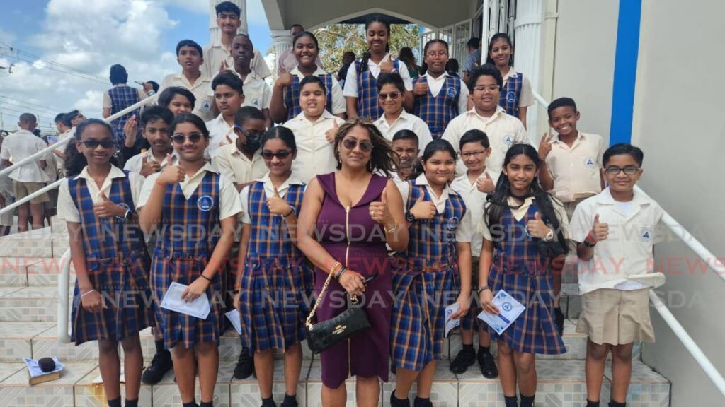 Students of Grant Memorial Presbyterian Primary School, along with their teacher Cheryl Ann Hernandez, give a thumbs up to indicate their readiness for the SEA exam at the Faith and Confidence service held at the Susamachar Presbyterian Church, San Fernando on March 20. - Photo by Yvonne Webb