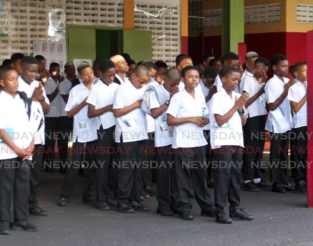 Students of Rosary Boys RC School stand in assembly for prayers before their Secondary Entrance Assessment (SEA) Examinations at Park St, Port of Spain on March 21. - Photo by Faith Ayoung